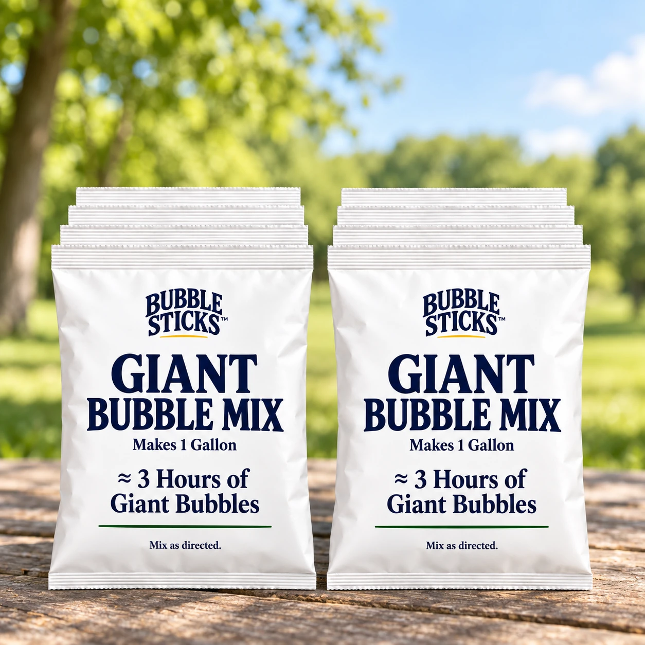 10 sealed white Bubble Sticks giant bubble mix refill pouches in compact stacks on a park picnic table